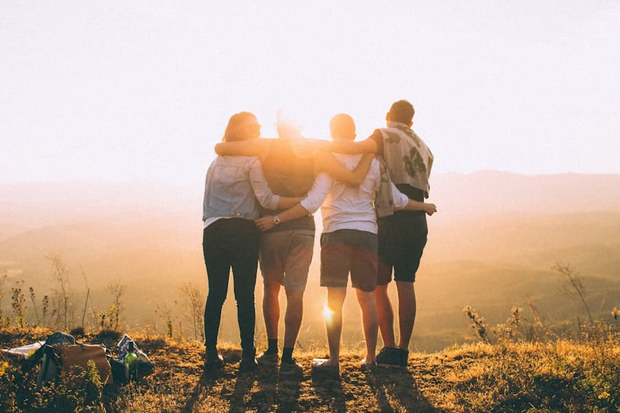 Friends arm in arm watching the sunset
