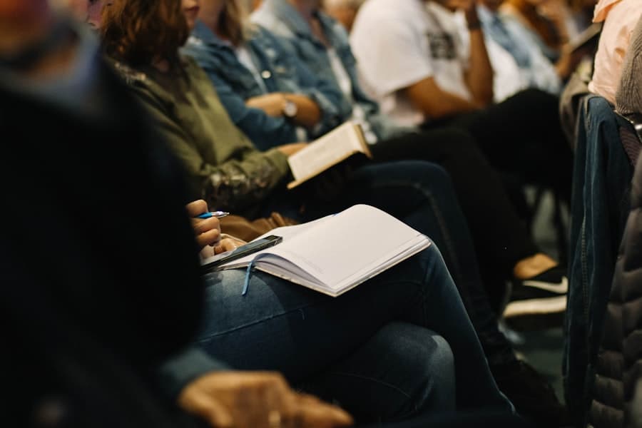 People seated in rows taking notes