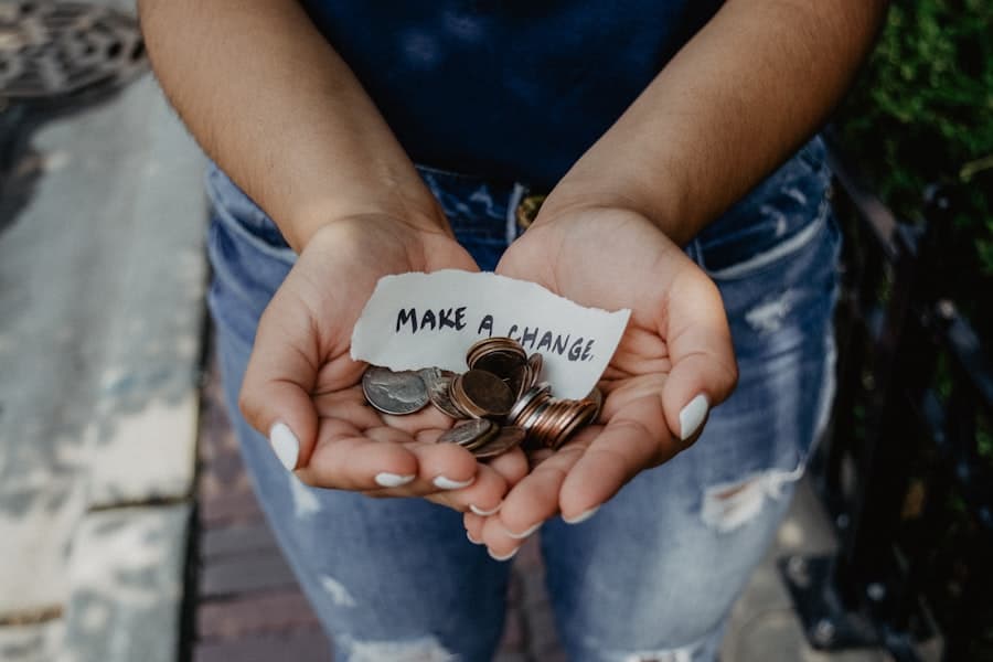 Open hands holding coins and a handwritten note