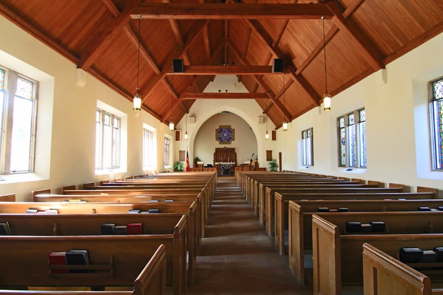 Wooden pews inside a warm, light-filled sanctuary