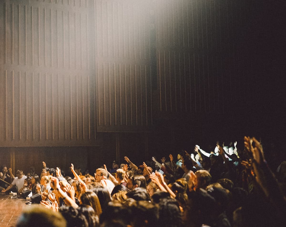 A congregation gathered in warm light
